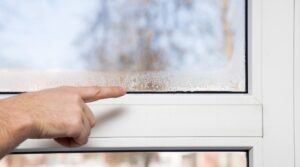 Pointing To Condensation On Window